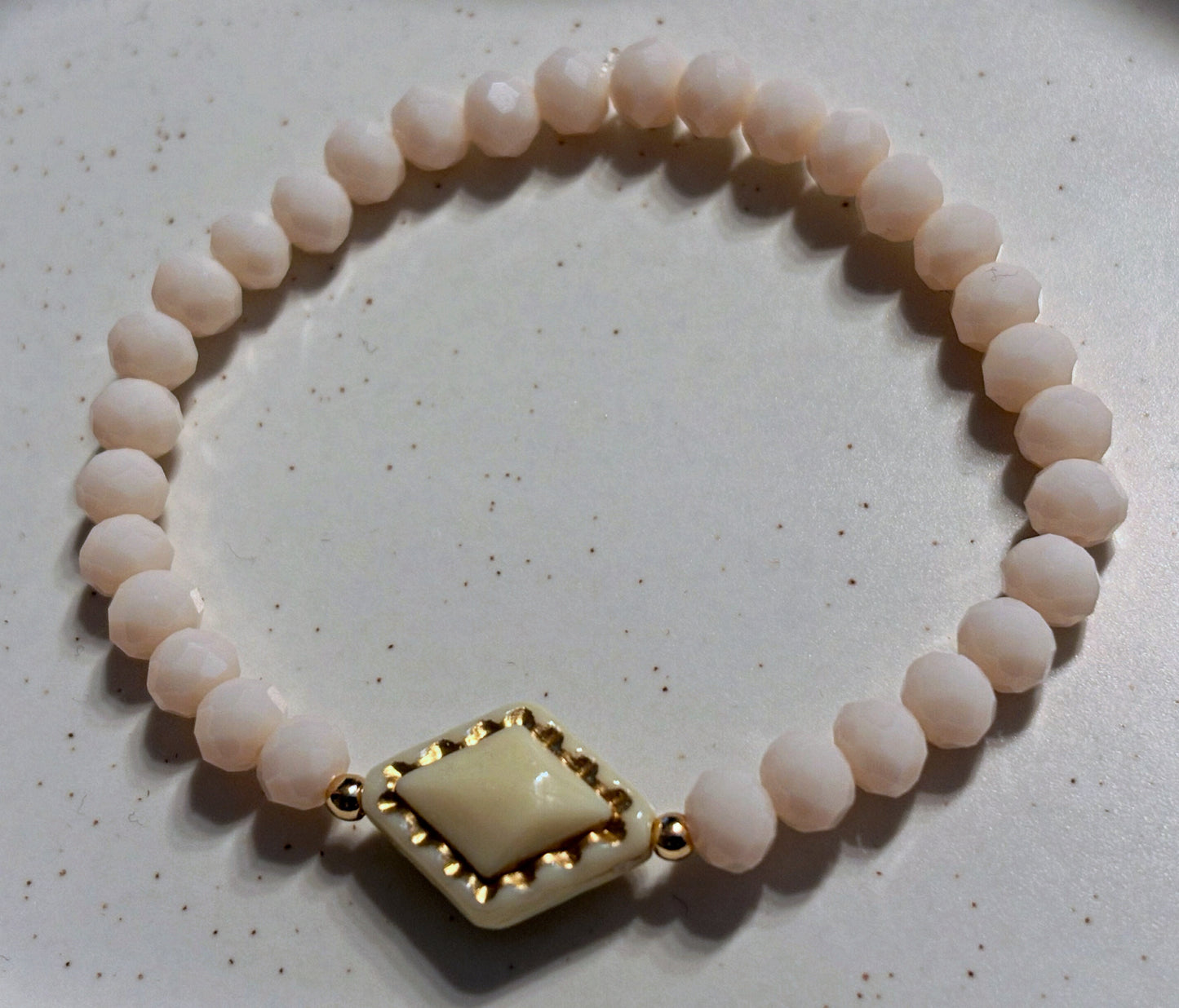 Bracelet cream tone with gold details