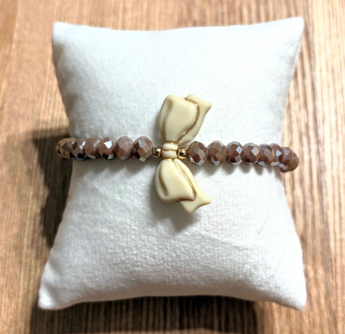 Brown bracelet with bow and gold details