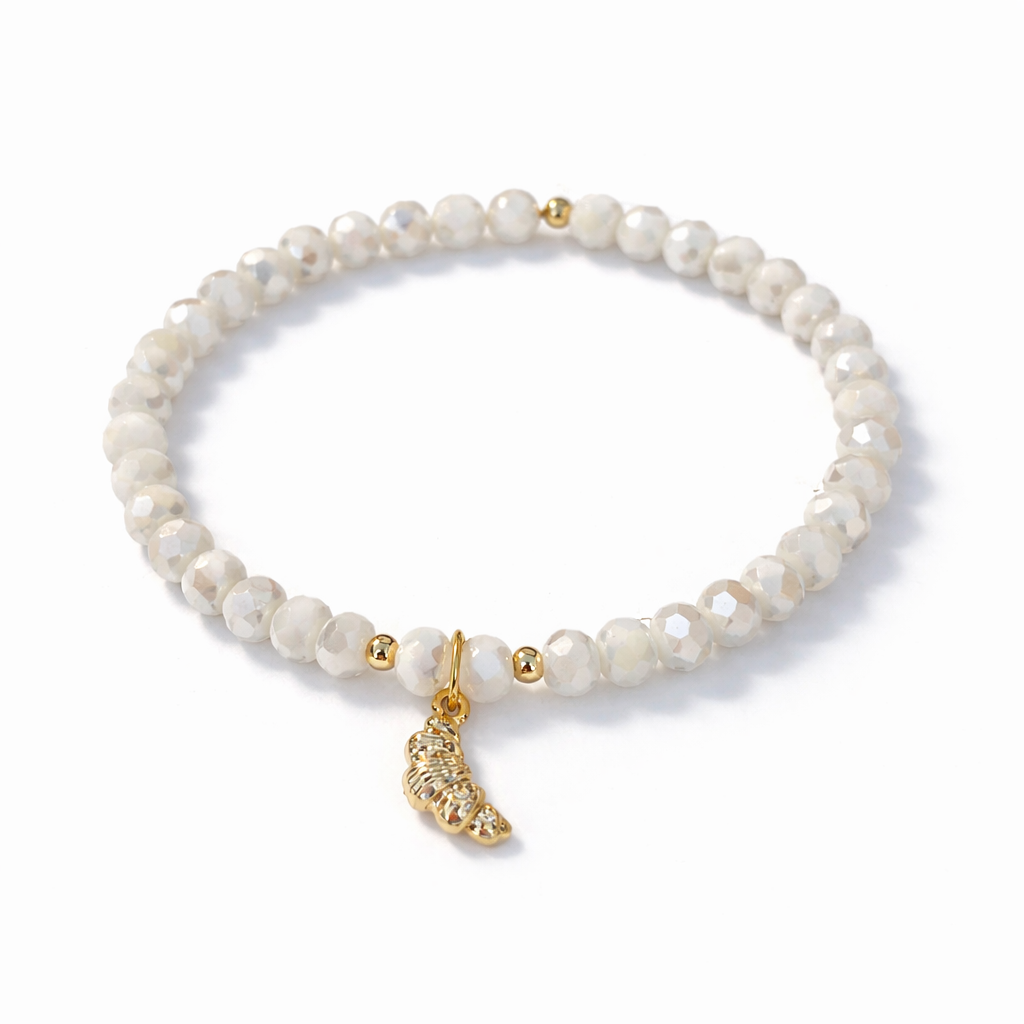 White bracelet with croissant charm and gold details