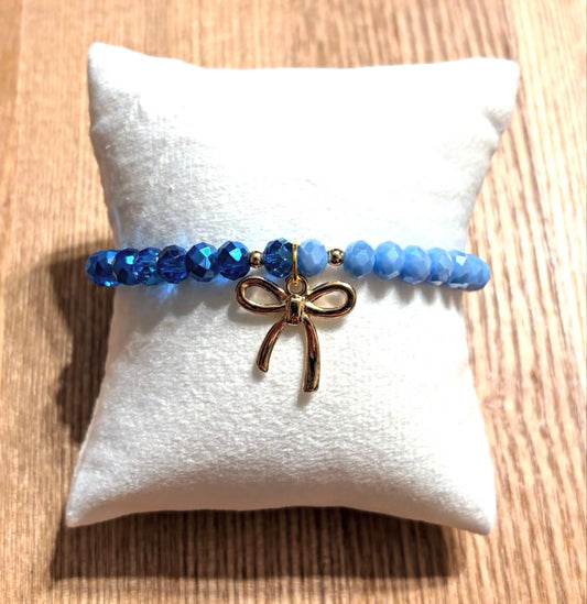 Blue bracelet with bow and gold details