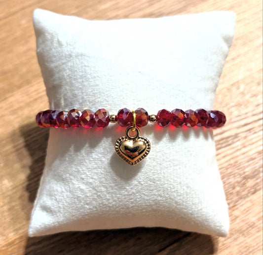 Red bracelet with heart pendant