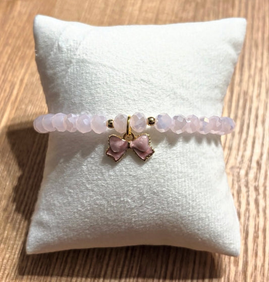 Pink bracelet with bow and gold details