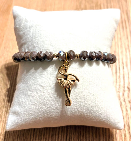 Brown bracelet with ballerina charm and gold details