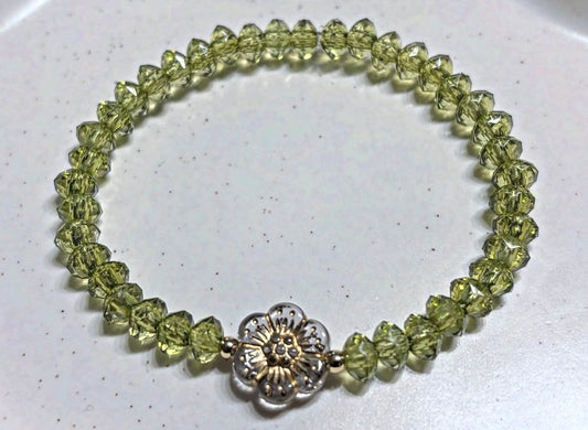 Light green bracelet with flower and gold details