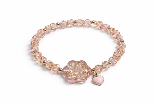 Pink bracelet with gold details and heart
