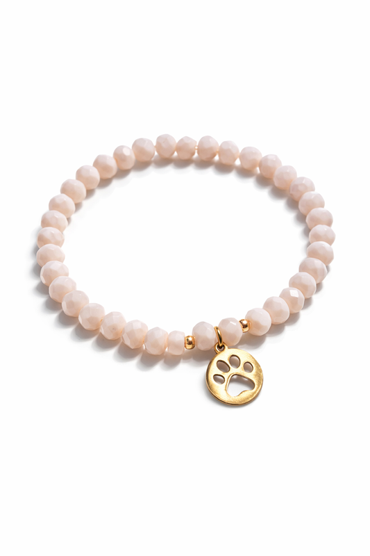 Bracelet made of shimmering pearls with golden paw print charms