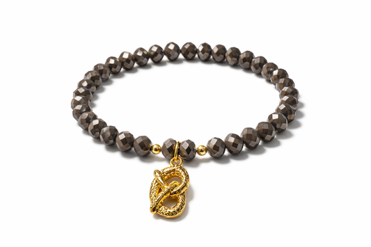 Brown bracelet with pretzel charm and gold details