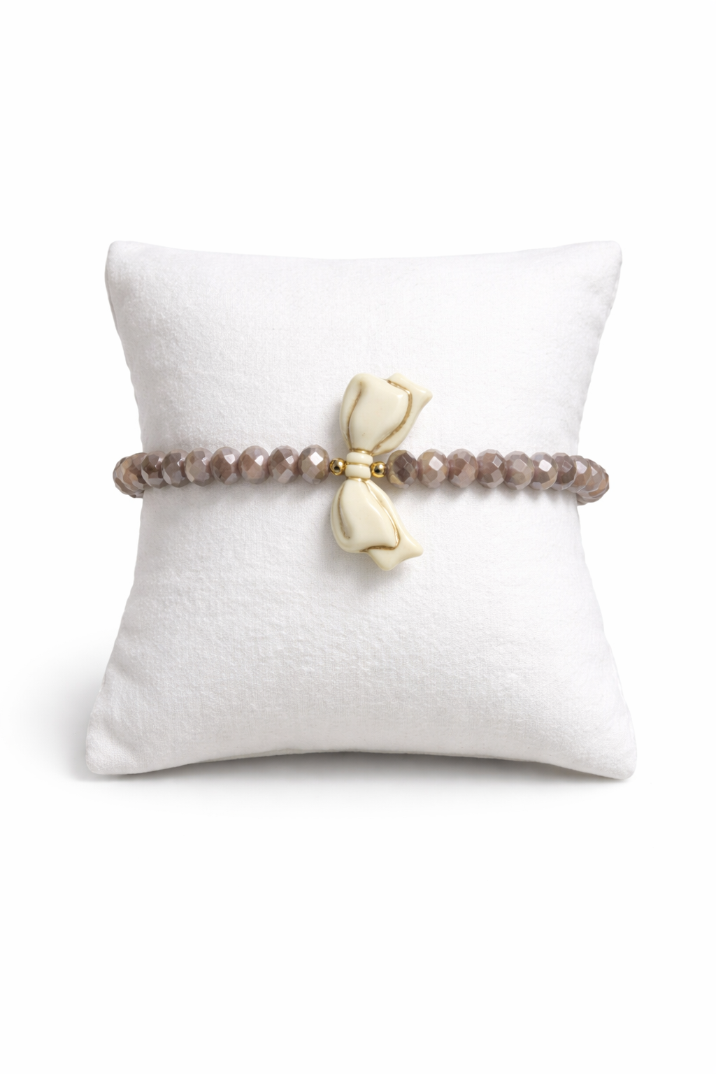 Brown bracelet with bow and gold details