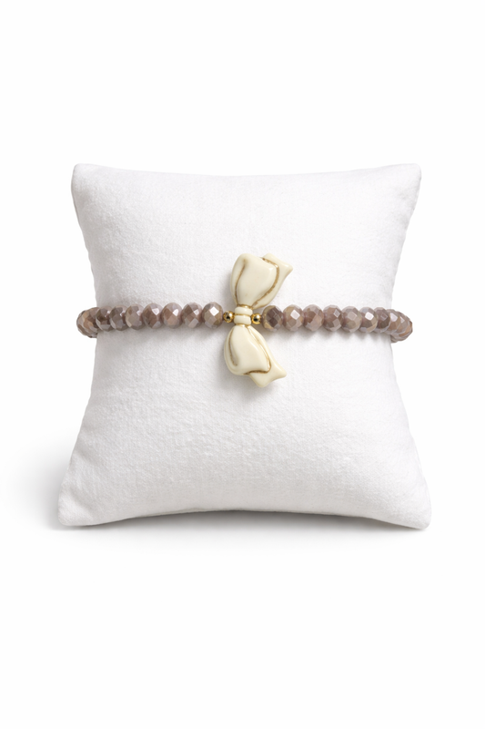 Brown bracelet with bow and gold details