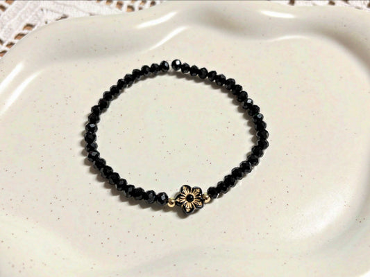 Armband schwarz mit Blümchen und goldenen Details